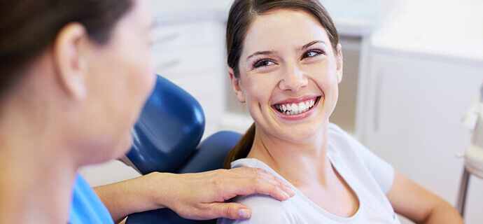 female patient smiling at dentist