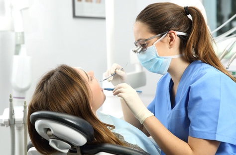 WWoman getting dental cleaning in Indianapolis
