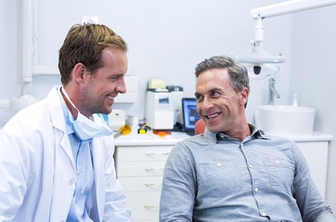 Patient and Indianapolis dentist discussing dental bridges