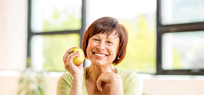 happy woman holding an apple