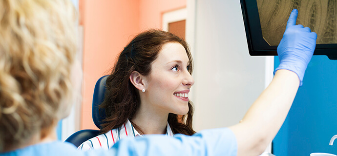 woman looking at radiography of teeth