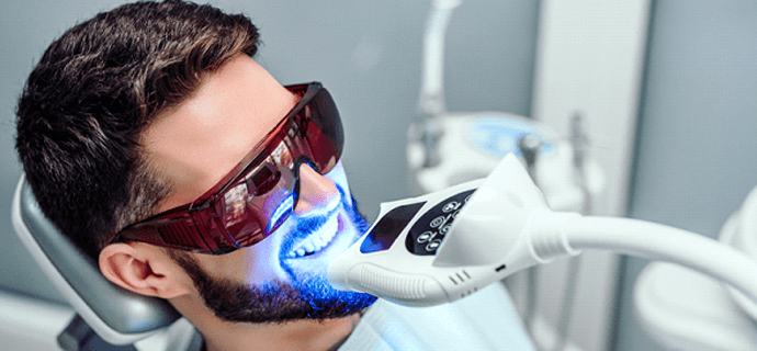 man undergoing in-office teeth whitening in Indianapolis