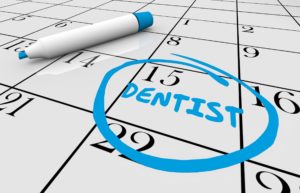 Calendar with appointment circled for dentist.