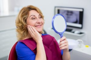older woman happy with dental implants